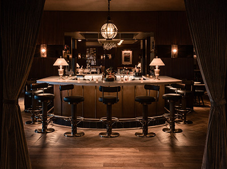 A bar with a chandelier above it