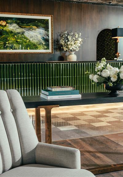 The Global Ambassador lounge area with couch, coffee table, and lamp