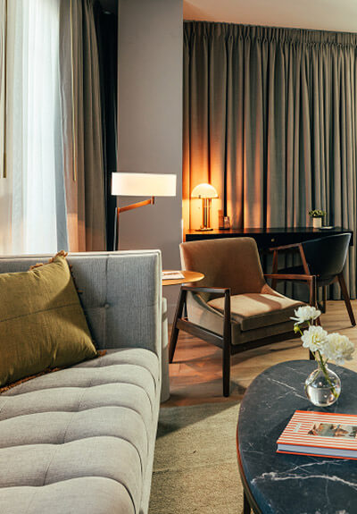 The Global Ambassador lounge area with couch, coffee table, and lamp