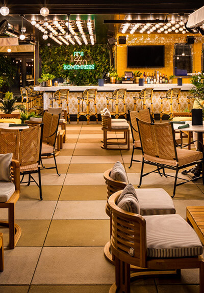 The Twelve Thirty Club Outdoor dining area at night with string lights